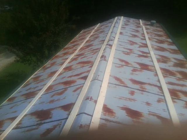 Rusted metal roof panels with new wood purlins before replacement — Storm Damage Roof Repair in Sand Springs by Roofing Brothers